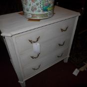 A French grey painted commode chest fitted three drawers on fluted supports