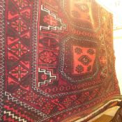 A Turkoman rug with four medallions surrounded by geometric motifs and a frieze and running border