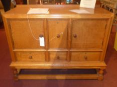 A Heals 1920`s honey oak sideboard fitted arrangement of four drawers and pair of cupboard doors