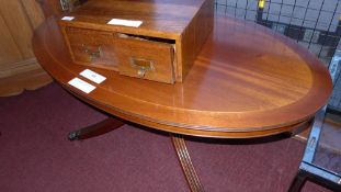 An inlaid mahogany low table the oval top raised on quadruped swept supports and castors