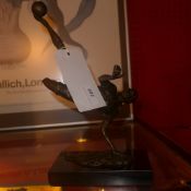 A bronze model of a footballer on marble pedestal base