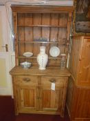A Victorian pine dresser the open shelved upstand above pair of drawers and pair of panelled doors