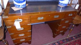 A Campaign style mahogany and brass bound pedestal desk the tooled leather top above arrangement