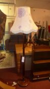 A mahogany standard lamp with silk shade