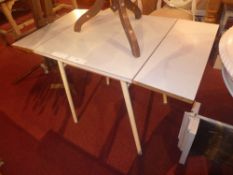 A retro formica topped twin flap kitchen table raised on metal supports