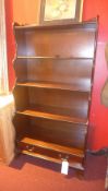 A mahogany waterfall style open bookcase fitted with two base drawers