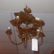 A gilt metal hanging chandelier with lea