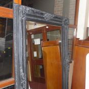 A rectangular wall mirror of large size