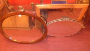 An oval mahogany mirror together with a