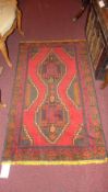 A Persian rug of small size the red grou