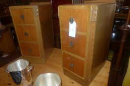 A pair of walnut three draw bedside ches