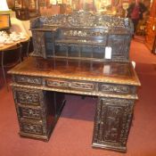 A C19th Chinese carved hardwood desk wit
