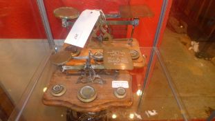 Two brass and oak postal scales with wei