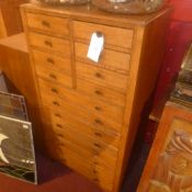 A light oak tall chest fitted with sixte
