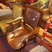 A C19th mahogany elbow chair with saddle seat and upholstered in leather (leather A/F)