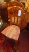 A set of four dining chairs with pierced backs above stuffover seats