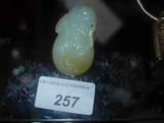 A Chinese carving of fruit with a mouse