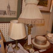 A carved giltwood table lamp and a brass