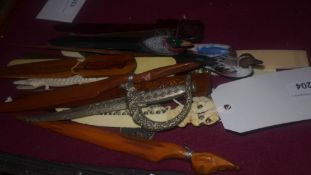 A collection of letter openers including