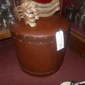 A brown leather upholstered footstool