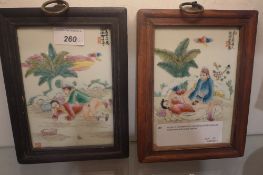 A pair of Chinese hand painted porcelain plaques decorated with erotic scenes