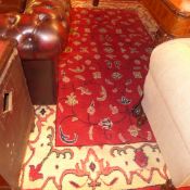 A hand knotted Persian rug with red fiel