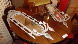 A pair of distressed finish wall mirrors