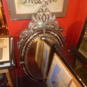 A Venetian style looking glass in a leaf