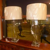 A pair of contemporary hollow glass tabl