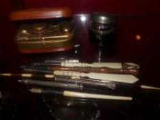 A collection of various pens including f