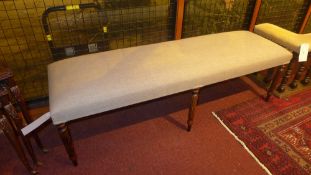 A window seat of elongated form upholste
