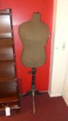 A vintage tailors dummy raised on turned column and tripod supports