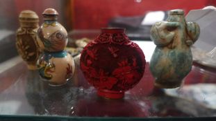 Four Chinese snuff bottles including jade enamelled and Cinnabar lacquer examples