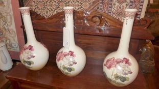 A set of three stem vases decorated with