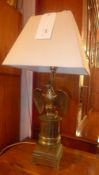 A brass eagle form table lamp with white
