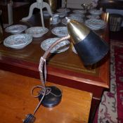 A 1950`s desk lamp with black painted shade on adjustable supports