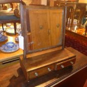 A Georgian mahogany toilet mirror in swi