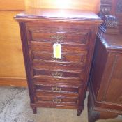 A C20th walnut continental five drawer chest with brass handles on turned feet
