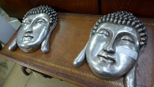A pair of silvered Buddha wall plaques