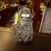 An African carved figure holding a dagge