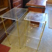 A pair of Lucite and brass three tier be