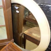 A large oval shagreen wall mirror with b