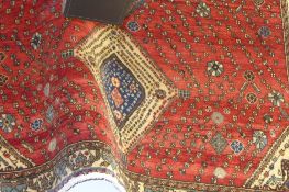 An extremely fine South West Persian Abadeh carpet repeating pole medallion on a terracotta field