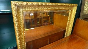 A large wall mirror the rectangular beve