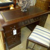 A mahogany pedestal desk the tooled leat