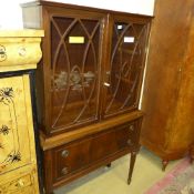 A C20th mahogany bookcase having glazed