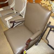 A Gainsborough chair upholstered in brown leather on stretchered supports
