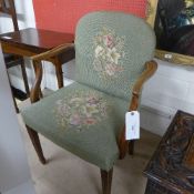 A Hepplewhite design walnut open armchair the oval pad back above wrap-over seat upholstered in