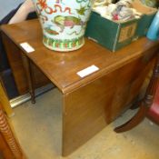A C20th mahogany large drop flap dining table raised on turned supports