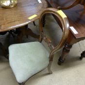 A set of four Victorian mahogany balloon back dining chairs with wrapover seats on cabriole